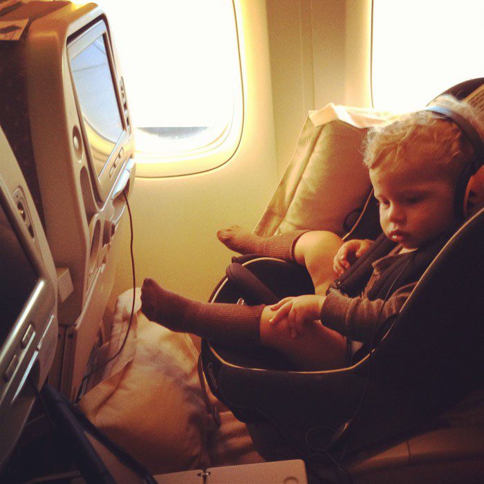 Baby in a car seat on a flight