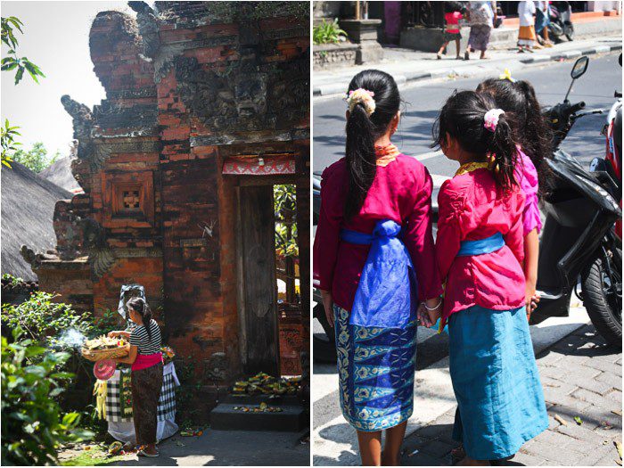 Temple in Seminyak and three Balinese girls waiting to cross the street