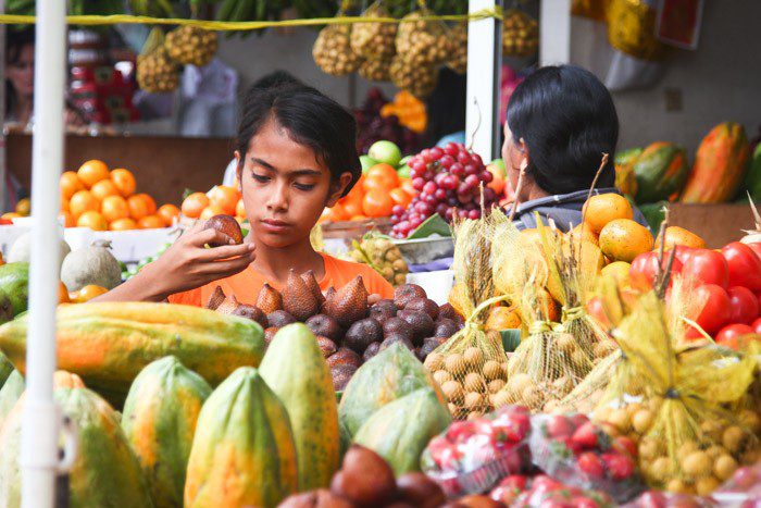 Woman inspecting fruit in Seminyak Market